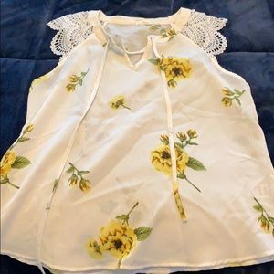 White and yellow floral blouse.